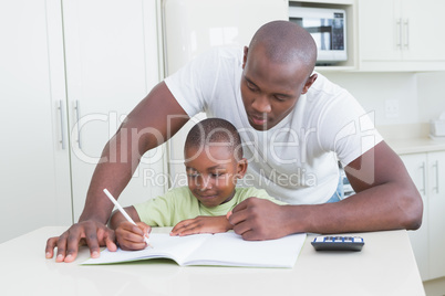 Happy smiling father working with his son