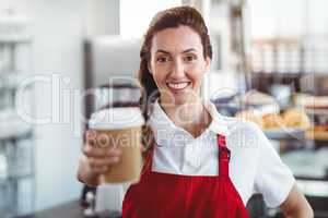 Pretty barista giving take-away cup