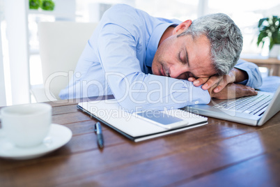 Businessman sleeping on laptop computer