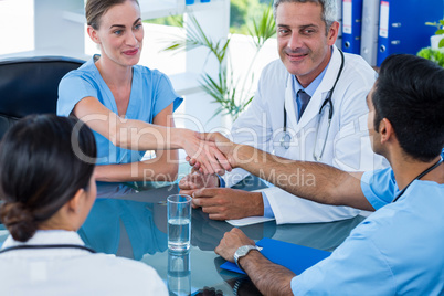 Doctors shaking hands during a meeting