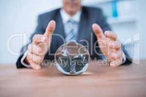 Businessman forecasting a crystal ball