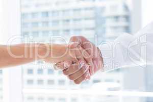 Close up view of two business people shaking hands