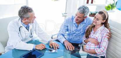 Pregnant woman and her husband discussing with doctor