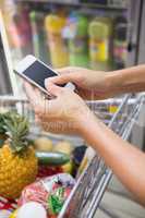 Woman buy products and using his smartphone