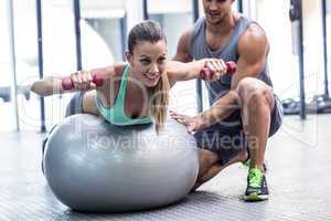 Muscular woman lifting a dumbbell