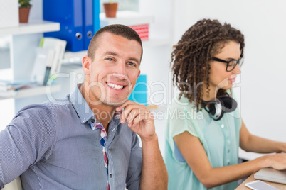 Smiling businessman looking at camera