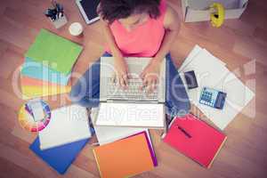 Young creative businesswoman working on laptop