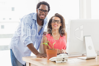 Two creative business colleagues looking at the camera