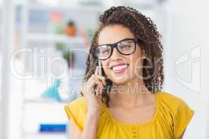 Smiling young businesswoman on the phone