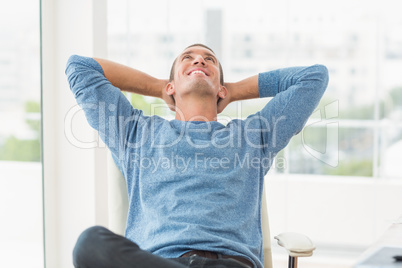 Relaxed creative businessman lying in a chair