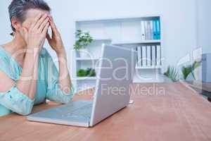 Worried businesswoman in front of her laptop