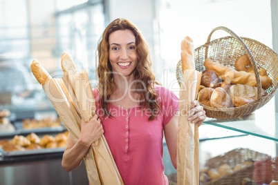 Pretty brunette holding baguettes