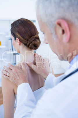 Doctor doing shoulder massage to his patient