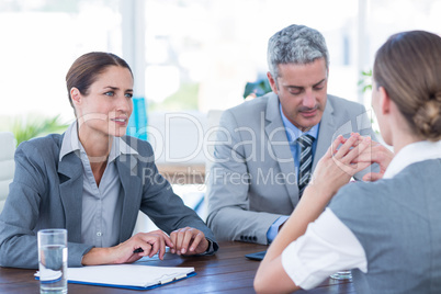 Business people interviewing young businesswoman