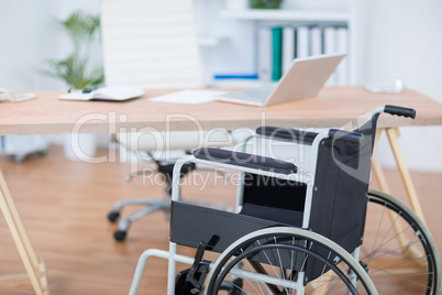 A free wheelchair at his desk