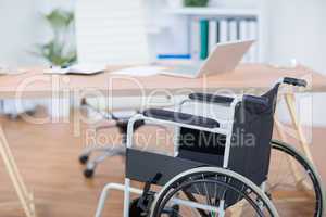 A free wheelchair at his desk