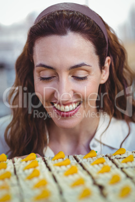 Pretty brunette looking at pastries