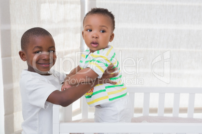 Portrait of a babyboy playing with his brother in his bed
