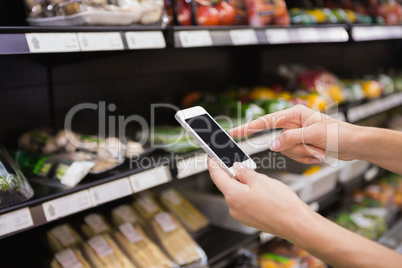 Woman buy products and using his smartphone