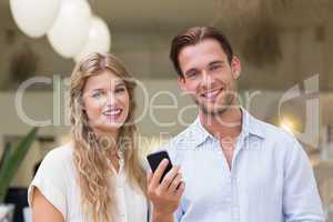 Portrait of a happy couple looking at smartphone