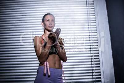A muscular woman ready to use the jump rope