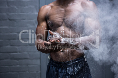 Young Bodybuilder shaking Chalk off his hands