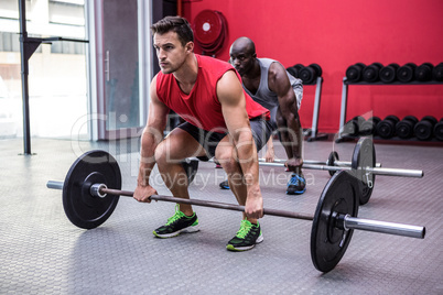 Three young Bodybuilders doing weightlifting