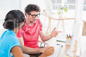 Casual business team working together with laptop