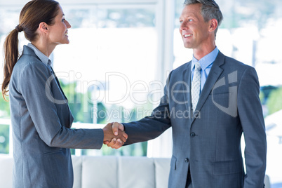 Two business workers shake hands