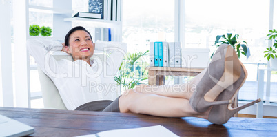 Businesswoman relaxing in a swivel chair