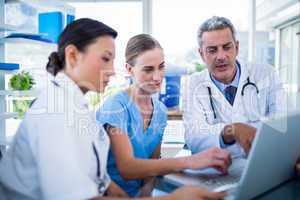 Doctors and nurse looking at laptop