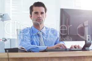 Serious businessman using computer