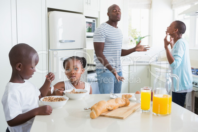 Happy family sitting and taking breakfast