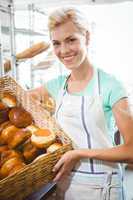 Smiling waitress carrying basket of bread
