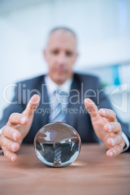 Businessman forecasting a crystal ball