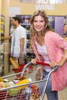 Portrait of a smiling blonde woman buying a products