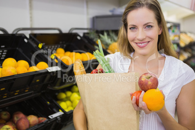 a pretty blonde with a grocery bag