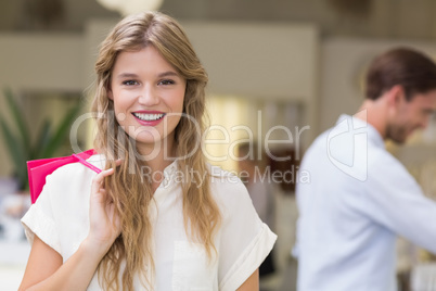 A pretty blonde woman with shopping bags