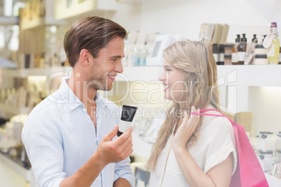 A couple testing a sample of beauty products