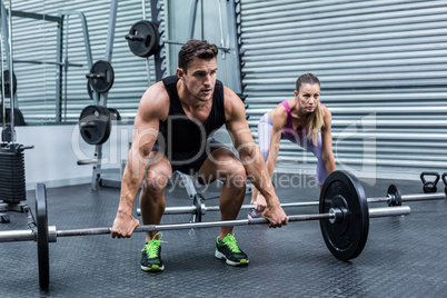 Muscular couple lifting weight together