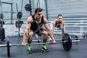 Muscular couple lifting weight together