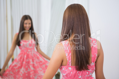 Smiling woman trying on a dress