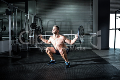 Muscular man lifting a barbell