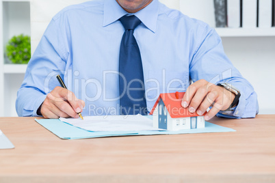 Businessman writing a contrat before signing it
