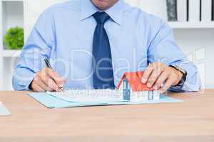 Businessman writing a contrat before signing it