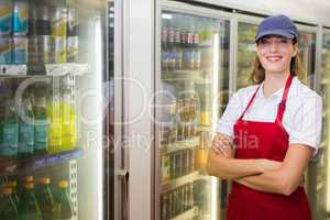 Happy pretty woman looking at camera with arms crossed