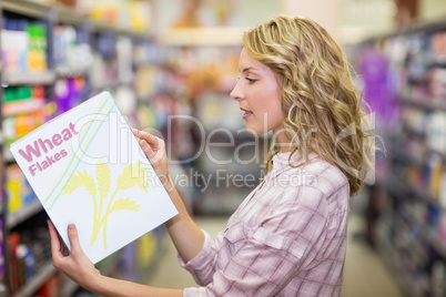 Side view of a pretty blonde woman reading a book