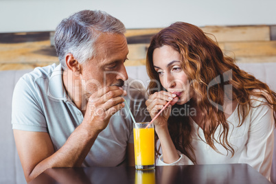 cute couple having glass of orange juice