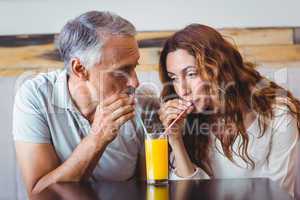 cute couple having glass of orange juice