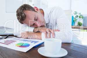 Exhausted businessman sleeping on the desk